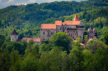 Beautiful old castle in forests with autumn landscape.Beautiful autumn landscape with colorful nature in the Czech Republic in autumn time..Pernstejn - Nedvedice © montypeter
