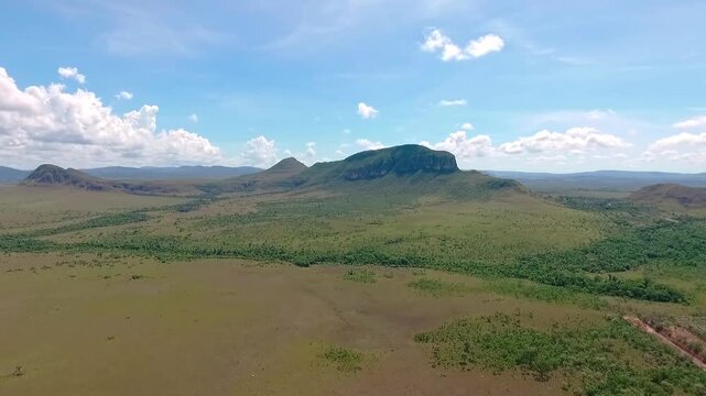 Expansive aerial view of the Brazilian savanna flying towards Morro da Baleia in Chapada dos Veadeiros National Park, a famous ecotourism spot