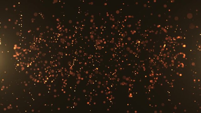 Orange glowing particles float through dark space, forming a vibrant abstract background with sparkling energy, motion, depth, and warmth.