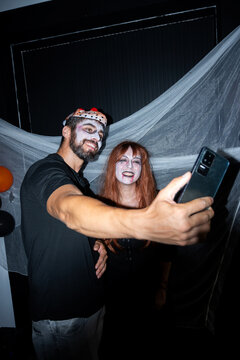 Friends taking a selfie at a Halloween party