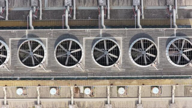 Overhead lateral view of industrial cooling fans on a rooftop