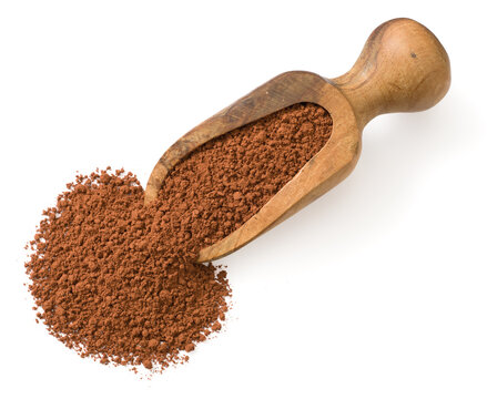 Raw cocoa powder in the wooden spoon, isolated on white background, top view.
