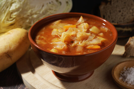 A bowl with traditional Russian cabbage soup shchi served in rustic style