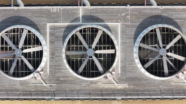Tightening overhead view of a large industrial rooftop cooling fan