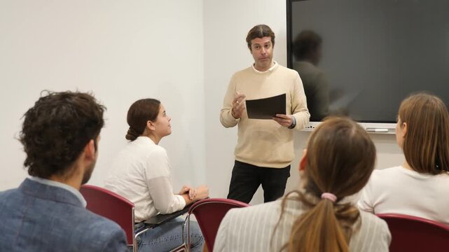 Knowledgeable professor explaining subject to classroom full of students 