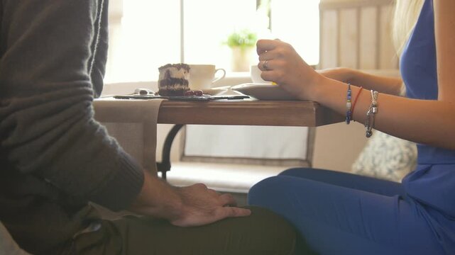 Man touching woman's knee during romantic date