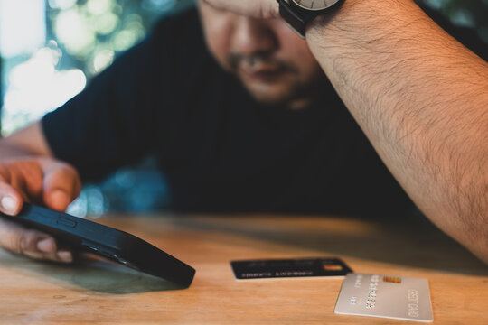 Asian man feeling stressed and worried because of unpaid bills and credit card debt