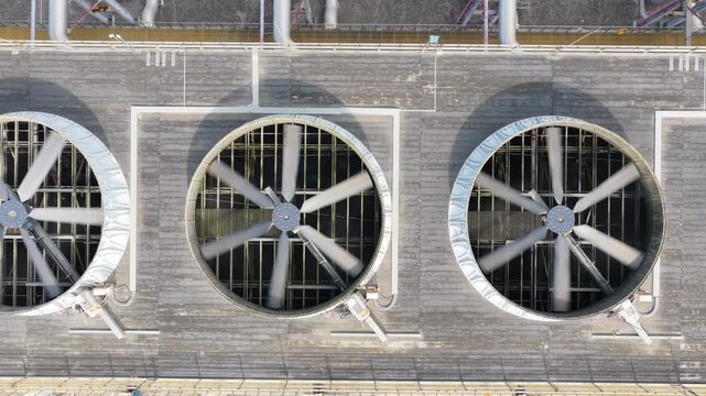 Close overhead tracking view of rooftop cooling fans