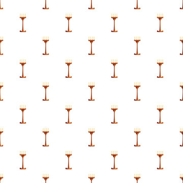Repeating pattern of traditional wooden candlesticks with burning flames on a white background