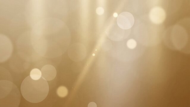 Golden abstract background featuring soft circular bokeh particles, shimmering lens flare effects, and warm glowing light rays in elegant design