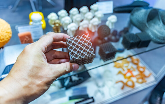 hand with flexible object printed on 3d printer close-up