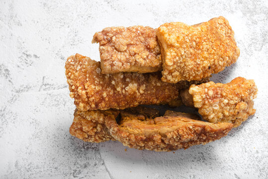Close Up of Crispy Chicharrones on Gray Cement Surface