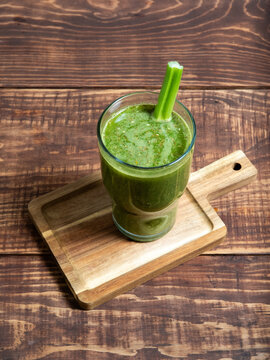 Green Juice in Glass on Rustic Wooden Table Viewed from Above