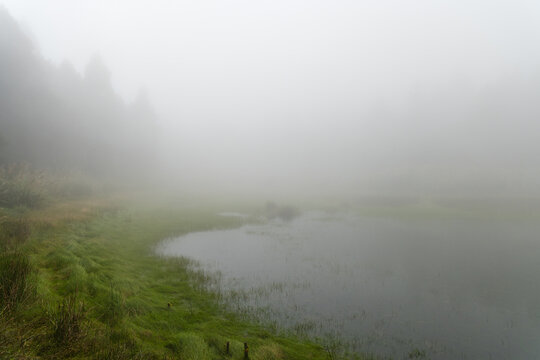 Misty fog over mountain lake water in taiwan
