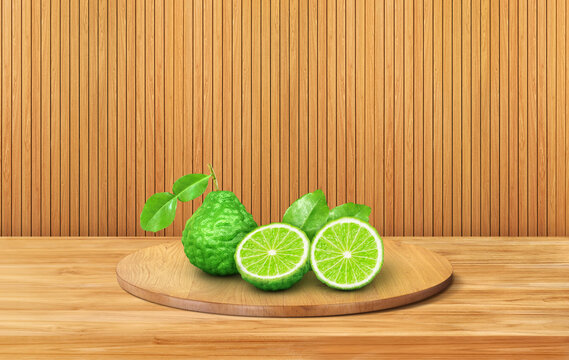 Fresh bergamot fruit with slices on wood podium.