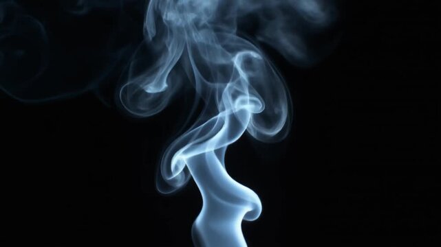 White smoke swirling gracefully against a dark black background in slow motion