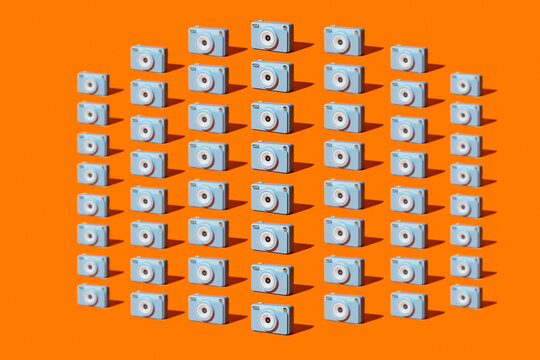 Blue cameras form a geometric pattern on an orange background