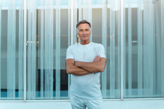 Confident man stands outdoors by a modern building in Barcelona