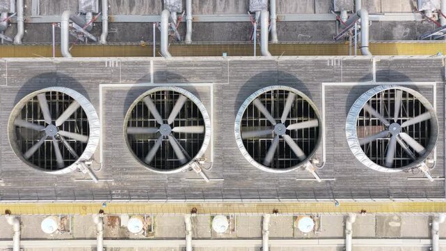 Overhead view of industrial fan rows and rooftop utility equipment
