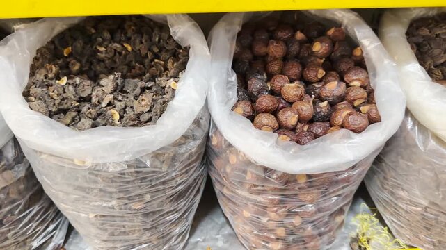 Amla and Soapnut or shikakai, black cardamom bags displayed in a market