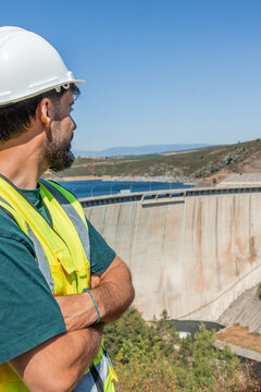 vertical Engineer inspecting hydroelectric dam infrastructure for renewable energy
