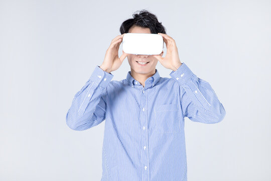 Young man wearing white VR headset smiling with eyes closed