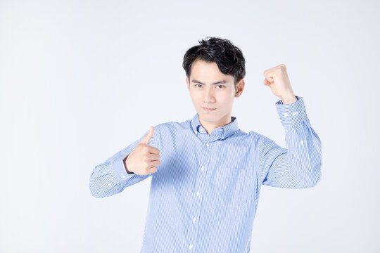 Confident Man Giving Thumbs Up With Raised Fist