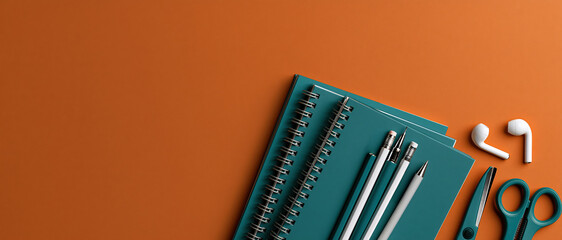 Obraz premium Vibrant backtoschool flatlay featuring teal spiral notebooks, pens, pencils, scissors, and wireless earbuds on bold orange. Perfect for education campaigns, student lifestyle, or.