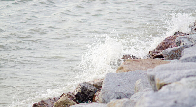 Waves in the sea crash against the rocks
