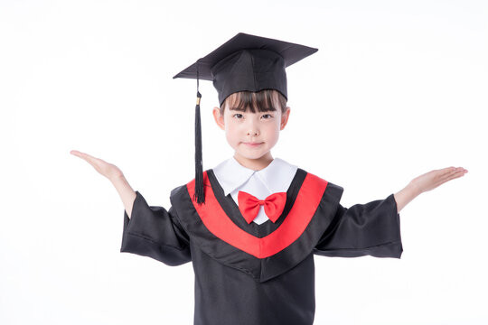 Little girl in graduation gown arms outstretched smiling