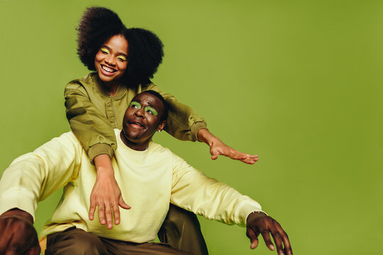 Woman and man friends dance together in the studio with playful youthful style