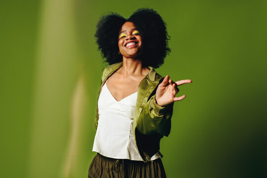 Dancing woman brings joyful lifestyle energy to a confident studio portrait