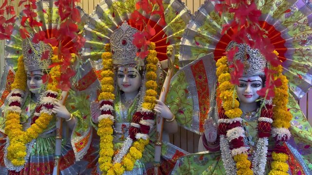 A vibrant devotional depiction of Lord Ram accompanied by Goddess Sita and Lakshman, richly decorated with floral garlands and traditional ornaments, representing divine companionship, devotion