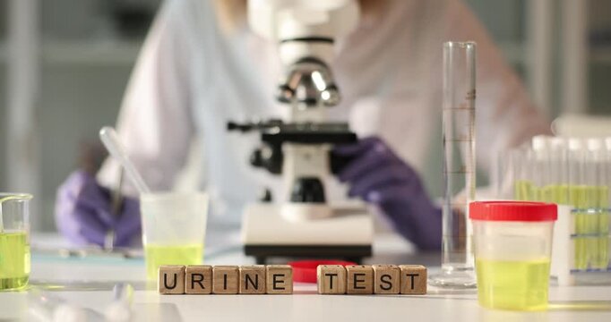 In a bright laboratory, a scientist examines samples under a microscope, carefully analyzing urine tests. Colorful containers and precise instruments surround the workspace.