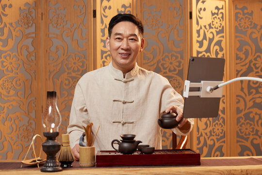 Asian Tea Master with Tablet and Tea Set