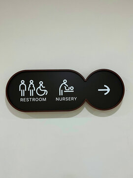 Black Public Bathroom and Baby Changing Room Directional Signboard Attached to Wall