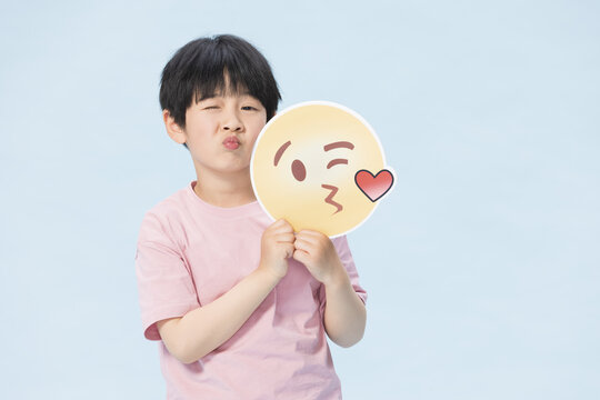 Boy Puckering Lips with Kiss Emoji Sign