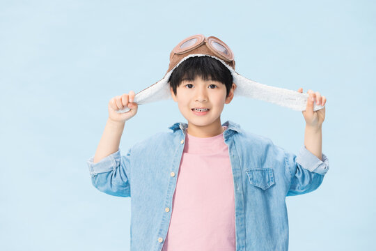 Boy Wearing Aviator Hat Smiling at Camera