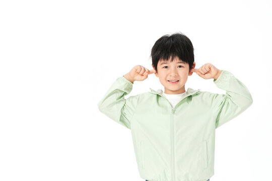 Boy Covering Ears With Fingers Playfully