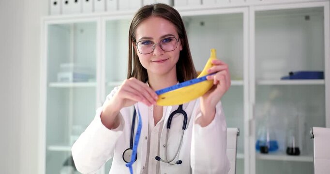 A scientist joyfully demonstrates the properties of elasticity by stretching a colorful banana in a vibrant laboratory setting. With glasses on and a stethoscope around her neck, she engages viewers.