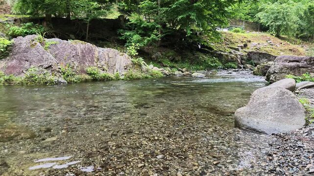 Boulder on a clear river bank in a green valley Hinohara Tokyo Japan