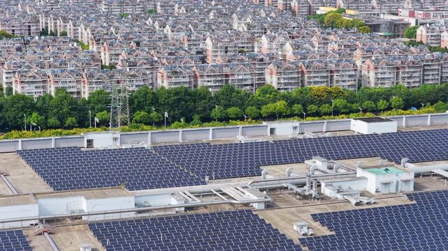 Lateral aerial view of rooftop solar panels near residential blocks