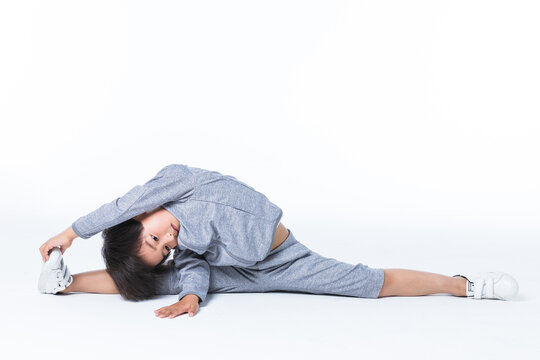 Boy doing yoga stretch in wide straddle pose