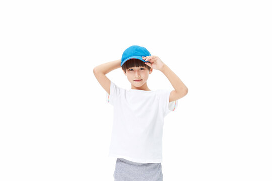 Boy Posing in Blue Cap and White Shirt