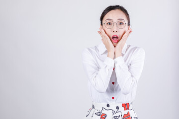 Woman in surprise with hands on cheeks and wide-eyed expression