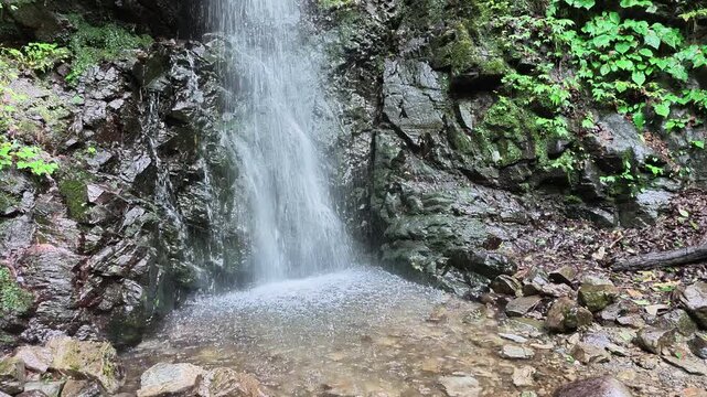 Ryujin Falls cascading over dark rock in Hinohara Tokyo Japan summer