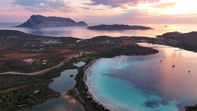 Aerial panoramic view of Cala Brandinchi beach and sunrise at Capo Coda Cavallo, Sardinia