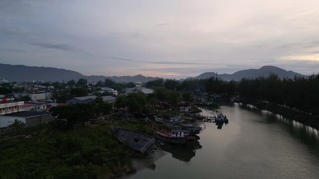 Banda Aceh, Indonesia : Aerial drone footage above the river in Banda Aceh of Sumatra, Indonesia. Taken with upward and tilt down motion revealing the crowded city at sunset