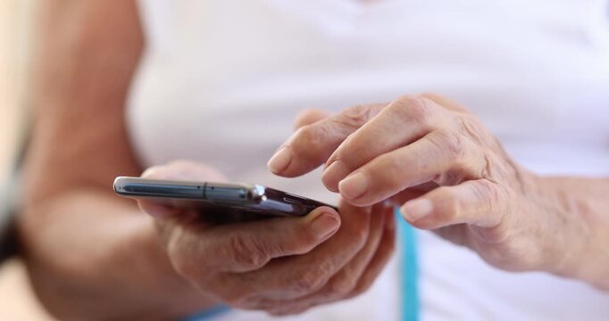 An individual engages with a smartphone, delving into various applications with curiosity and focus in a warm, inviting room.