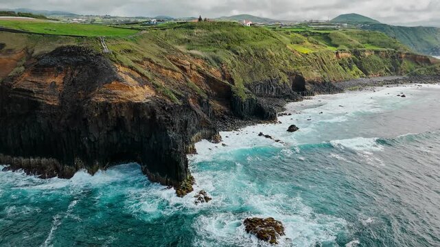 Volcanic basalt cliffs form remote Atlantic coastline on Sao Miguel, Azores. Wide aerial landscape